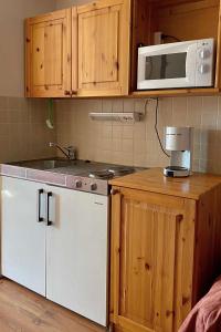 a kitchen with a microwave and a dishwasher at Motel Patalahti in Jämsä