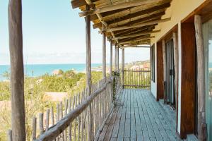 a balcony of a house with a view of the ocean at Tree House Villa in Praia do Tofo
