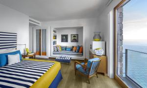 a bedroom with a bed and a view of the ocean at Maison La Minervetta in Sorrento