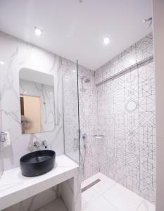 a bathroom with a black sink and a shower at Rotonda Hotel in Thessaloniki