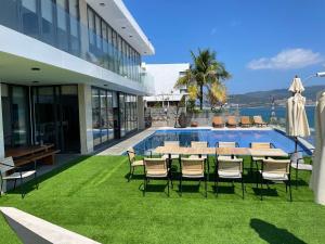 a patio with a table and chairs next to a pool at Harbor View Villa in Nha Trang