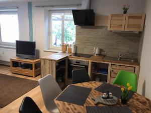 a kitchen and dining room with a table and chairs at Ferienwohnung in Burg in Fehmarn