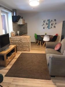 a living room with a couch and a television at Ferienwohnung in Burg in Fehmarn