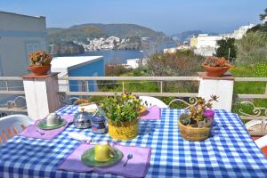a table with a blue and white checkered table cloth at Maridea - Le Conchiglie in Ponza