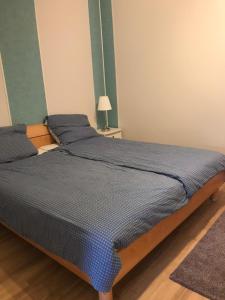 a bed with a blue comforter in a room at Ferienwohnung in Burg in Fehmarn