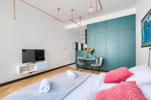 a bedroom with a large bed and a tv at Rynek Starego Miasta 19 in Warsaw