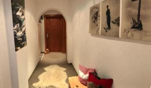 a room with a hallway with a rug and a door at Gästehaus Ulrich Neuner in Wallgau