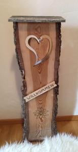 a wooden stand with a heart sign on it at Gästehaus Ulrich Neuner in Wallgau
