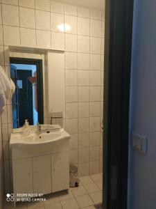 a bathroom with a sink and a mirror at Bacchus Panzió in Eger