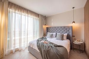 a bedroom with a bed and a large window at Nasma Luxury Stays - Boulevard Central Tower in Dubai