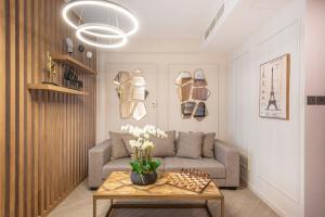 a living room with a couch and a table at Nasma Luxury Stays - Boulevard Central Tower in Dubai +44 photos