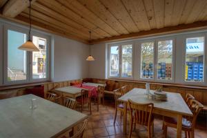 a restaurant with tables and chairs and windows at Forst´s Landhaus in Riedenburg