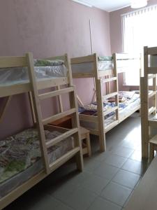 a room with three bunk beds and a window at Lyudmila in Podgorenskiy