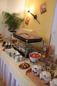 a buffet with plates of food on a table at Hainbuchhof in Anger