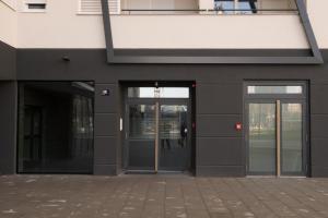 an entrance to a building with two revolving doors at Roomies Zagreb in Zagreb