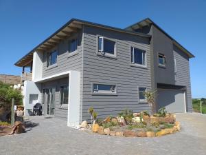a large house with aphalt at Lovely new flat near restaurants and beach with solar - free wifi and DSTV in Cape St Francis