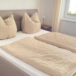 a bed with two pillows on top of it at Buchensteinblick in Sankt Jakob in Haus