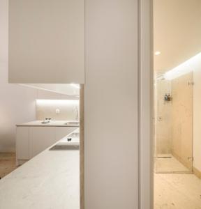 a kitchen with white walls and white counters at Lisbon Serviced Apartments - Mouraria in Lisbon