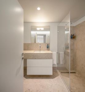 a bathroom with a sink and a shower at Lisbon Serviced Apartments - Mouraria in Lisbon