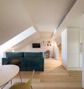a living room with a blue couch and a table at Lisbon Serviced Apartments - Mouraria in Lisbon