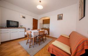 a kitchen and dining room with a table and a couch at Apartment Ante Kampor in Kampor