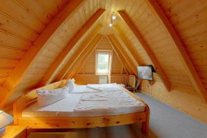 a bedroom with a bed in a wooden attic at Strandvogt4 WT12 in Dorum-Neufeld