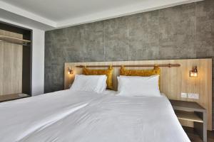 Voodi või voodid majutusasutuse Ivy Hotel - Adults Only toas