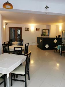 a dining room with a white table and chairs at PENSIUNEA HORA in Braşov