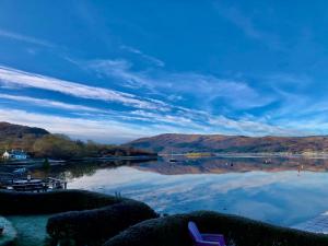 a view of a lake with mountains in the background at An Airigh, overlooking Loch Fyne in Cairndow