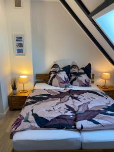 a bed with a comforter on it in a room at Strandnah in Wenningstedt in Wenningstedt