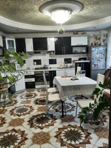 a kitchen with a white table and chairs in it at У Ані in Lazeshchyna
