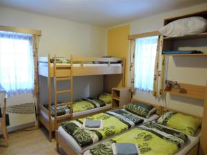 a room with two bunk beds and a room with two beds at Penzion nad Sněžným potokem in Žacléř