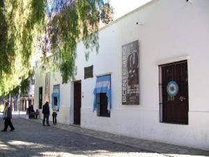a white building with people walking on a street at Departamento en San Juan, Argentina in San Juan +14 photos