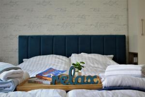 a bed with books and a plant on top of it at Vip House 2 in Vrnjačka Banja