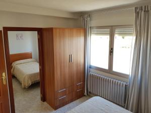 Posteľ alebo postele v izbe v ubytovaní Vivienda Turística El Asturiano