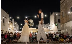 a man and a woman walking down a runway in front of a crowd at Casa Tramonto in Alliste