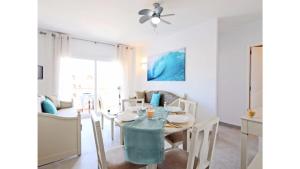 a dining room and living room with a table and chairs at Apartamentos Sema in Son Servera