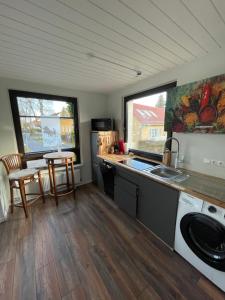 a kitchen with a sink and a stove top oven at Appartement Seebadallee mit Klimaanlage und Wallbox für e-Autos in Rangsdorf +30 photos