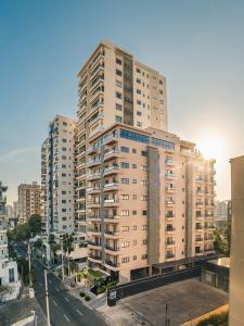 a tall building with a street in front of it at Regatta Living Hotel By Mint in Santo Domingo