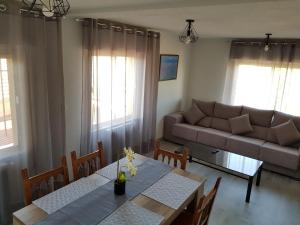 a living room with a table and a couch at Vivienda Turística El Asturiano in Montamarta
