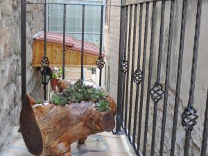 a wooden log planter with plants in it next to a fence at Apartments Lana in Split