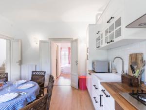 a kitchen with a table with two sinks and a counter at Apartment Tenuta Naiano Raffaello in Cavaion Veronese