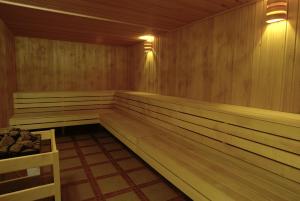 a sauna with wood paneled walls and a bench at Panorama SPA Aparthotel Schillerhof by AlpenTravel in Bad Gastein
