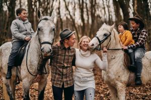 a group of people riding on horses in the woods at Tmbin's barn - nature, horses, family in Sežana