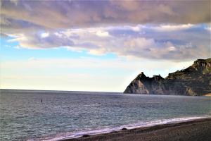 a view of the ocean with a beach and cliffs at Camping La Focetta Sicula in SantʼAlessio Siculo