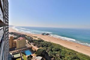 a view of a beach and the ocean from a building at Stella Maris 144 in Amanzimtoti
