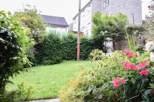 a garden with pink flowers and a building at Lovely Sunny 2 Bed Home Edinburgh Coast in Edinburgh