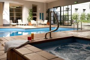 a swimming pool with a jacuzzi tub in a house at Grand Hotel Melbourne in Melbourne