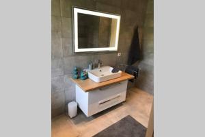 a bathroom with a white sink and a mirror at Zeit für Dich am Bergelchen, Winterberg in Winterberg