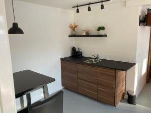 a bathroom with a sink and a desk in a room at B&B 't Onderkomen in 't Harde